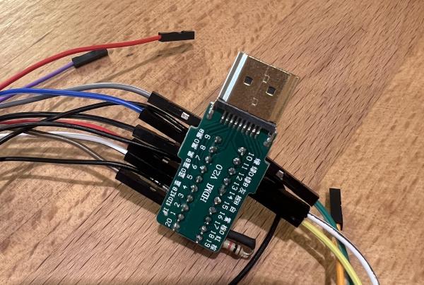 A HDMI breakout board with two columns of cables being inserted into their sockets; looks like a frankenstein octopus. Looks legit